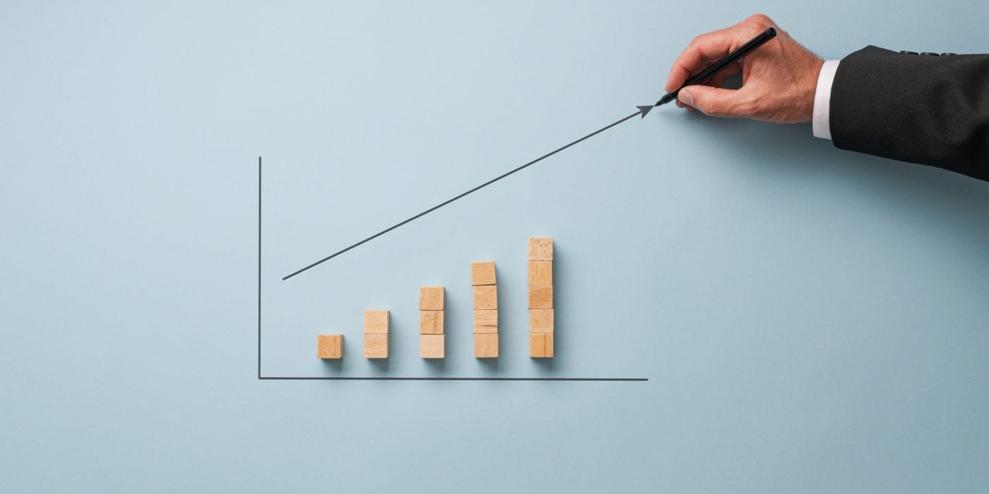 Businessman drawing financial graph